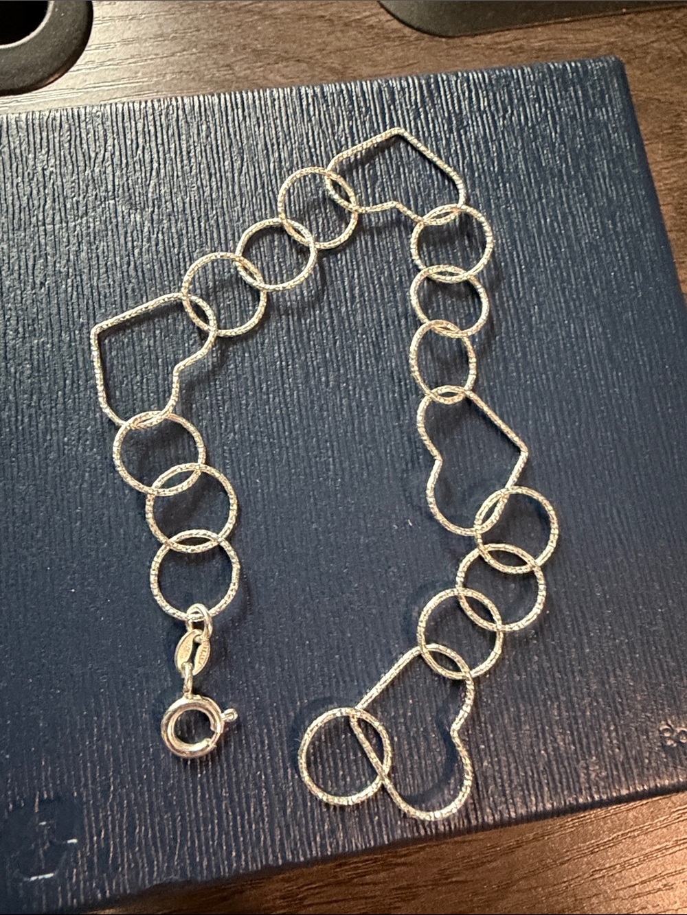 Sterling silver textured heart link bracelet.